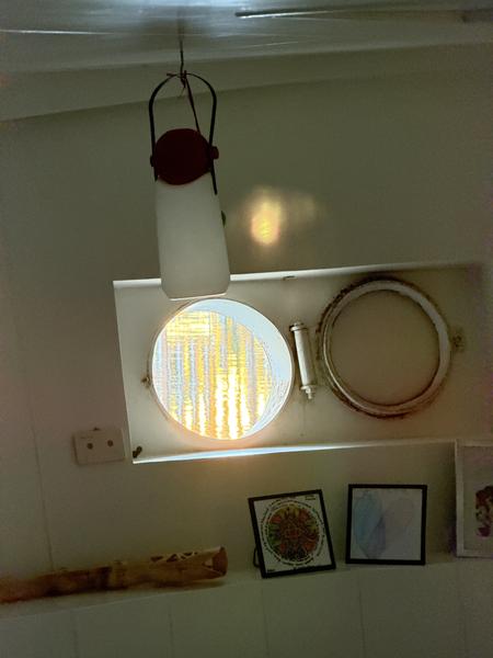 This photo captures a warm and inviting interior, likely within a canal boat in Oudeschans, Uilenburg, Amsterdam